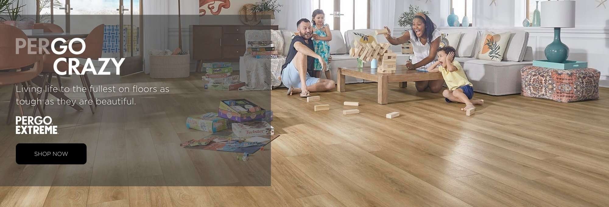 Young family playing games in an open living room featuring durable Pergo flooring